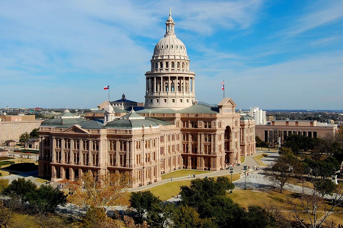 The Texas State Capitol in Austin under a clear blue sky